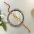 Radiant Harmony: Four Pearl Designer Rakhi