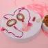 Elegant Pink Pearl Rakhi Set with Sweets & Almonds